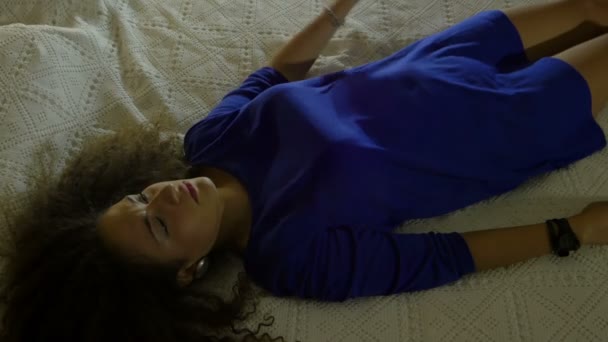 Молодая женщина ложится на кровать: усталая, подавленная, одинокая — стоковое видео