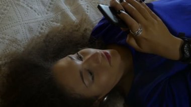 güzel kadın yatakta cep telefonunda mesaj yazarak: smartphone