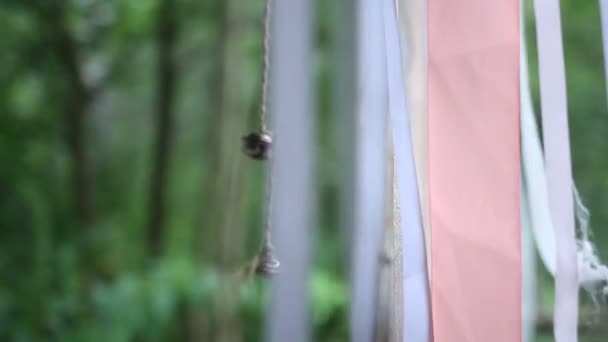 Bell hanging on a ribbon in the wind — Stock Video