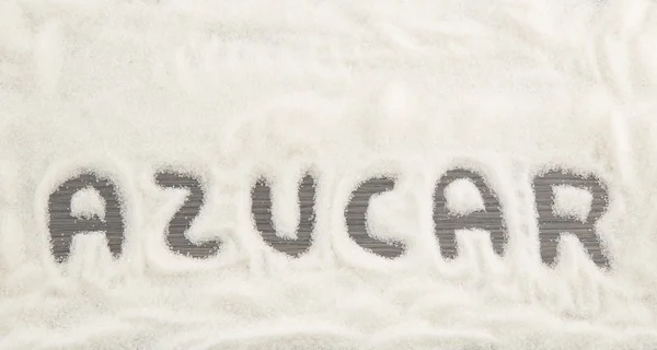 Zucchero di iscrizione trasformato in mucchio di zucchero semolato bianco — Foto Stock