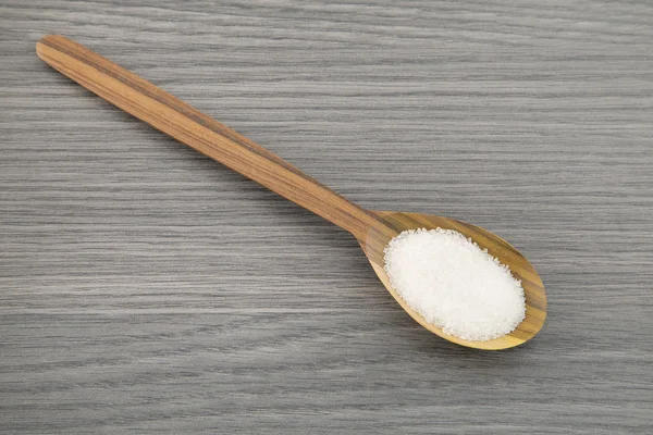 Cucchiaio da zucchero su fondo di legno — Foto Stock