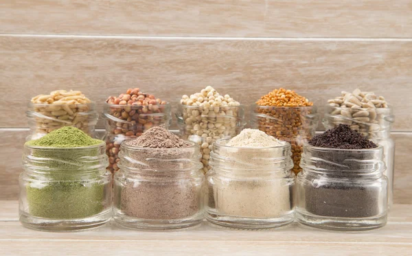 Variety of spices and grains on wooden background — Stock Photo, Image