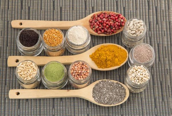 Variety of spices and grains on wooden background