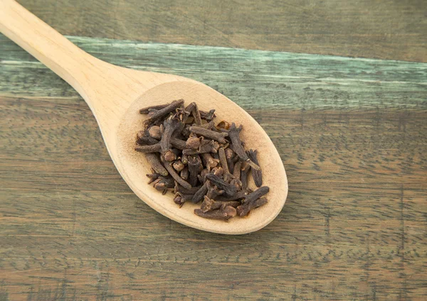 Cloves in wooden spoon — Stock Photo, Image