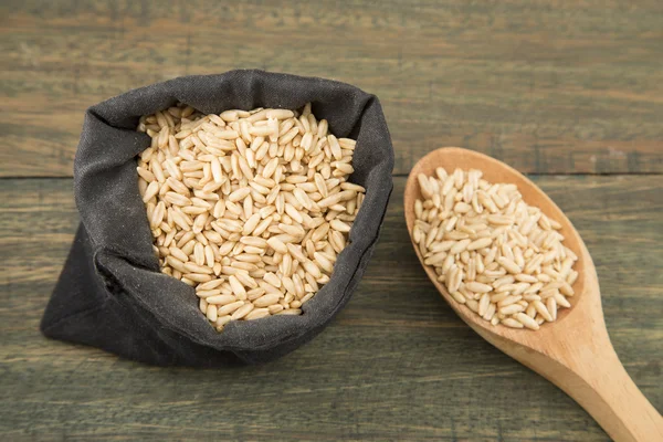 Oat grains on wooden background — Stock Photo, Image