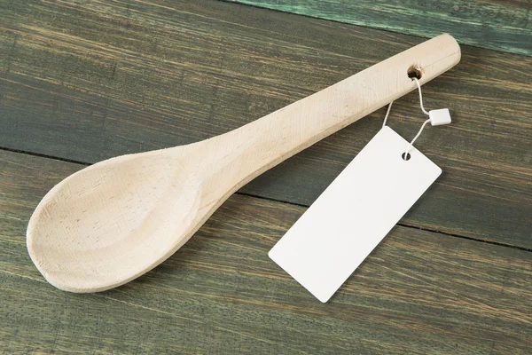 Wooden spoon with label — Stock Photo, Image
