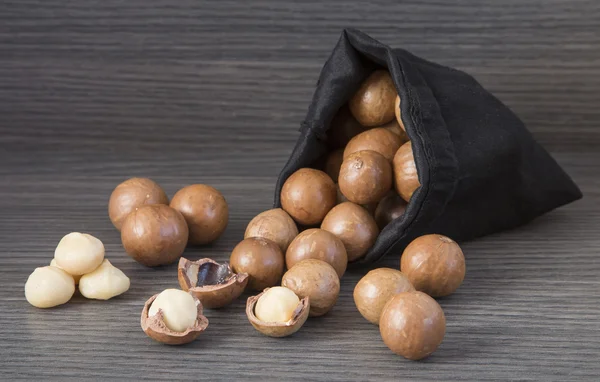 Macadamia nuts on wooden background — Stock Photo, Image