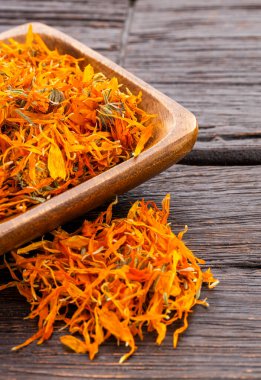 Calendula officinalis - Kare ahşap bir kasede organik takvim yaprakları