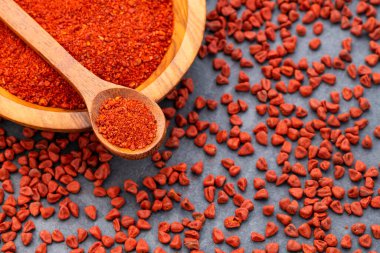 Kaşıkta ve kasede ezilmiş annatto tohumları - Bixa Orellana