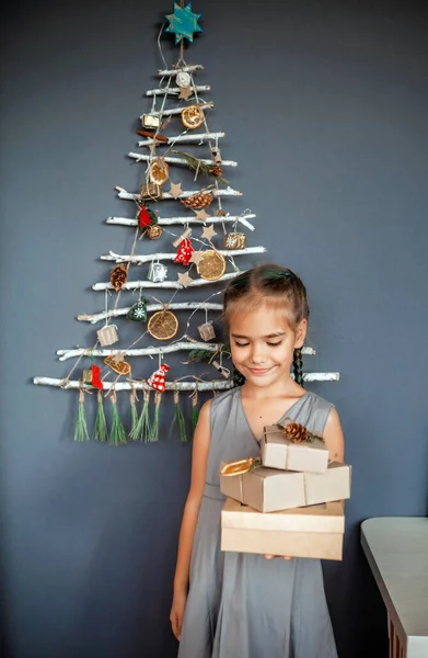 Happy Girl Holding Out Present Box Original Alternative Christmas Tree — Stock Photo, Image