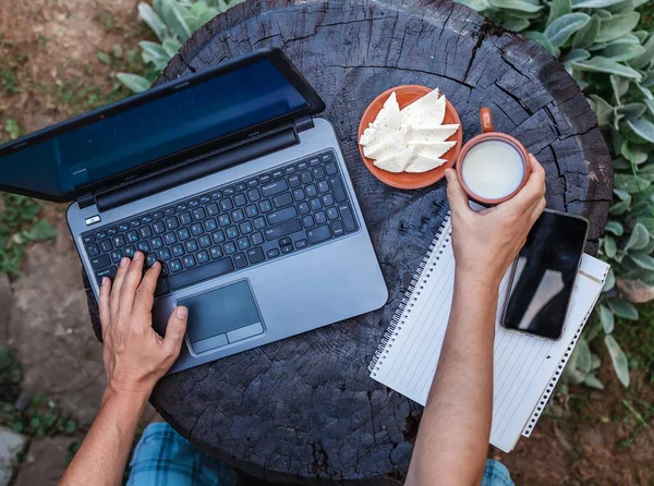 Home office concept, distant working during lockdown. A man, freelancer, working remotely in the farm at countryside, with cheese and ecological milk, online education and job, countryside lifestyle