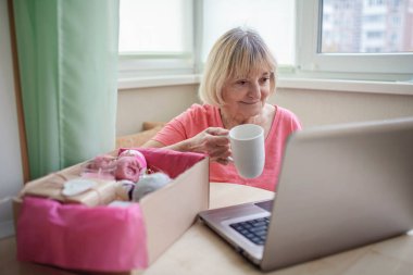 Sevgililer ve Anneler Günü için doğal kozmetik ürünleriyle dolu kutuları açan kadın.