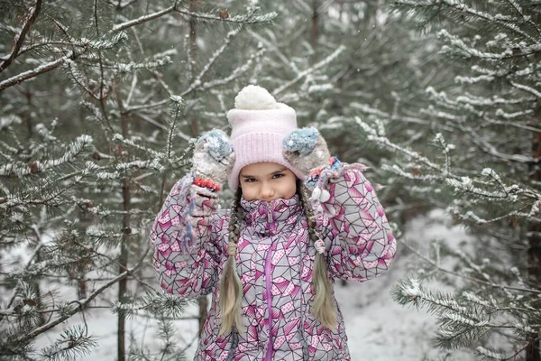 Kids enjoy first snow in winter forest, active seasonal activities, lifestyle