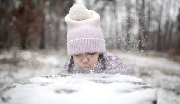 Kids enjoy first snow in winter forest, active seasonal activities, lifestyle Stock Image