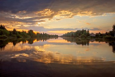 Gölün üzerinde muhteşem bir gün batımı, ayna gibi su, altın saatler, alacakaranlık, yerel seyahat ve doğa.