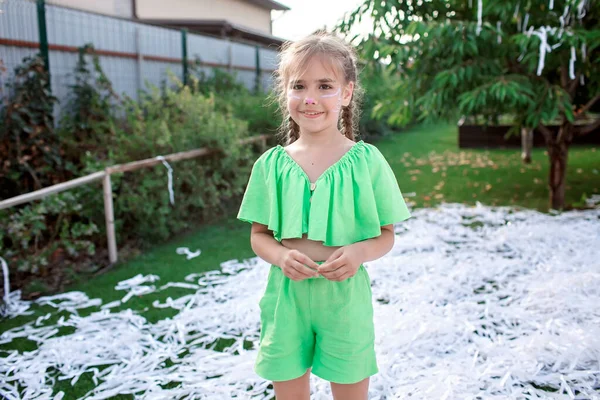 Happy kids enjoy paper show on backyard, outdoor birthday party, celebration in the garden