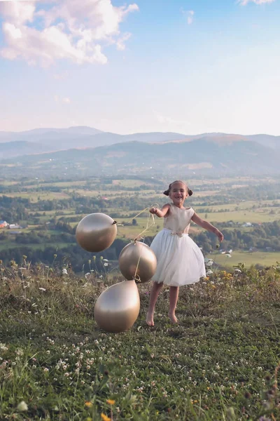 Party after lockdown. Girl dancing alone with air balloons on the top of the mountains, new normal — Stock Photo, Image