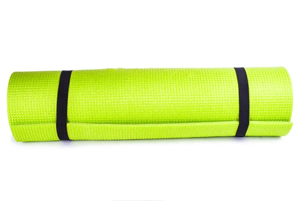 Sportuitrusting, gerold groen yoga mat — Stockfoto