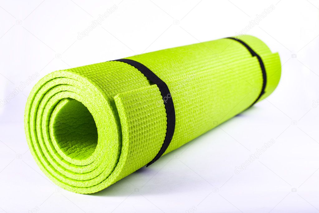 Rolled sport mat green for exercise.
