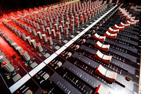 detail sound mixer in red and white light with great perspective