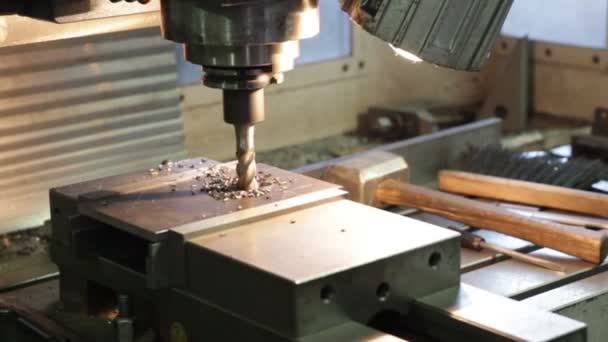 Drilling machine making a hole in a steel bar — Stock Video