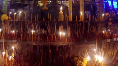 bir Budist sunağında yanan sopalar ve mumlar