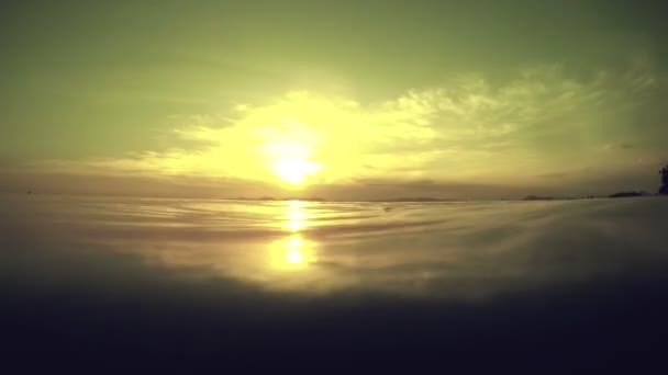 Calm sea surface from underwater at sunset — Stock Video