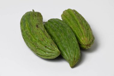 Close up of a bunch of green bitter melon used for vegetable food on a white isolated background.