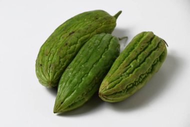 Close up of a bunch of green bitter melon used for vegetable food on a white isolated background.