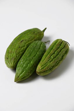 Close up of a bunch of green bitter melon used for vegetable food on a white isolated background.