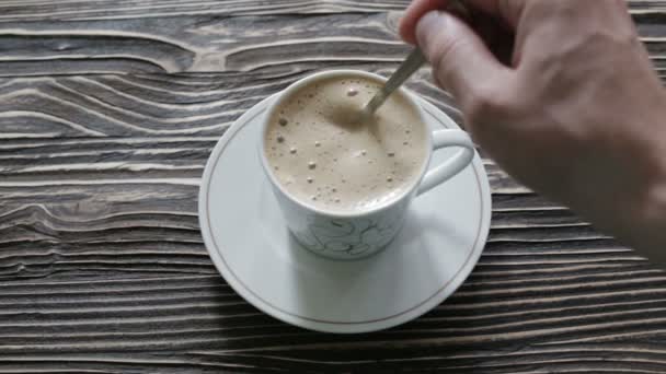 Una tazza di cappuccino con schiuma è sul tavolo — Video Stock