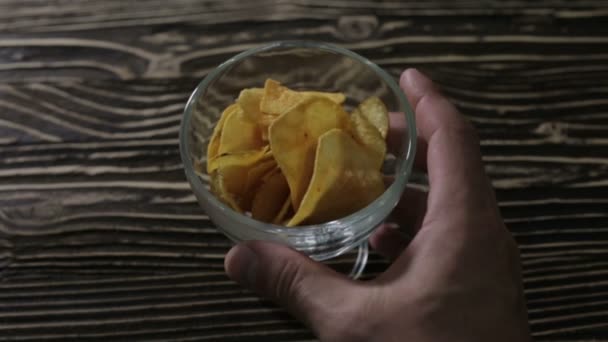Chips are in a glass vase on the table — Stock Video
