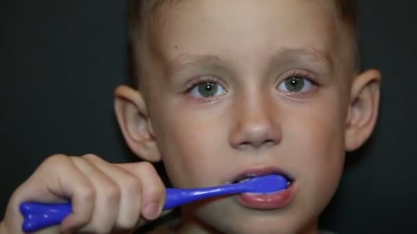 En pojke borstar tänderna — Stockvideo