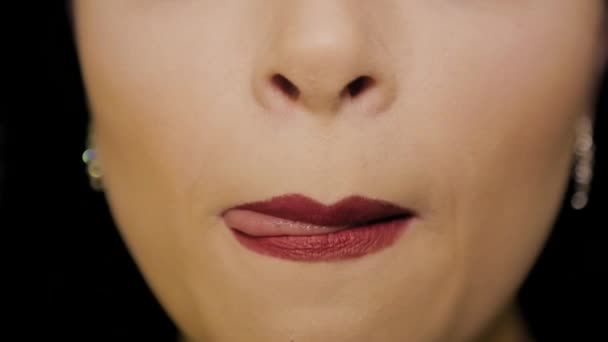 Woman licks his lips with red lipstick — Stock Video