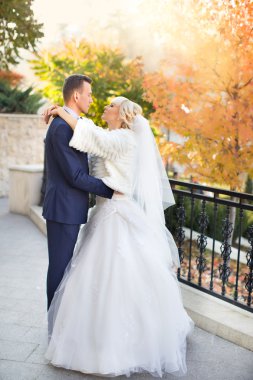 Gelin ve damat bir yürüyüşe kırsal bir yolda kucaklamak