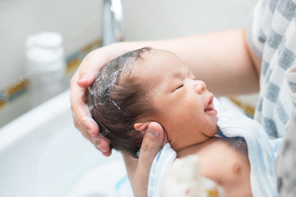 Asian newborn baby having a bath