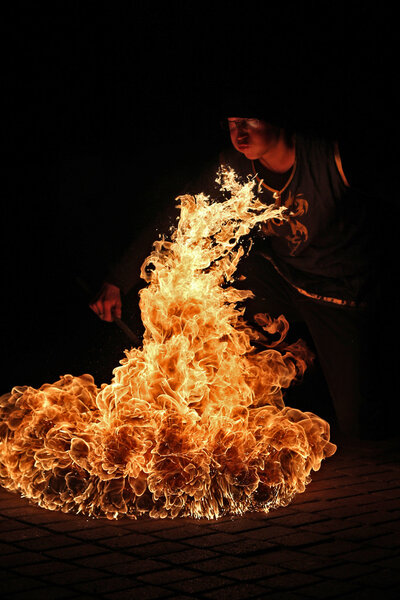 Fire artist performing fire breathing 