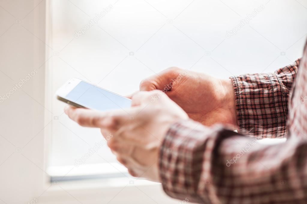 men holding mobile phone close-up shot