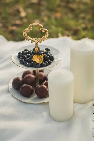 Autumn Still Life: plum, blueberry and candles — Stock Photo, Image
