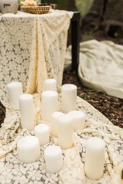 Wedding decoration on boho style: white candles — Stock Photo, Image