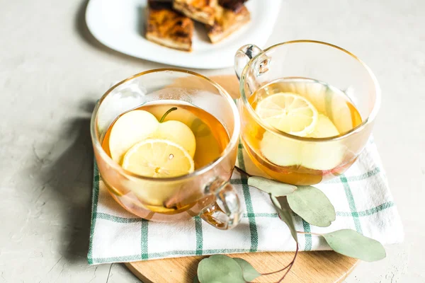 Cup of green tea with cinnamon, lemon and apples, baklava — Stock Photo, Image