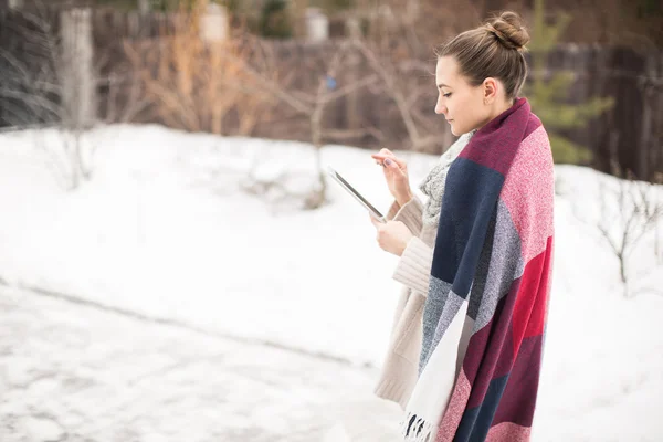 Mujer joven con la tableta en la calle en invierno — Foto de Stock