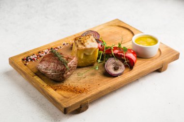 Izgara et ve sebze soslu restoran yemeği.