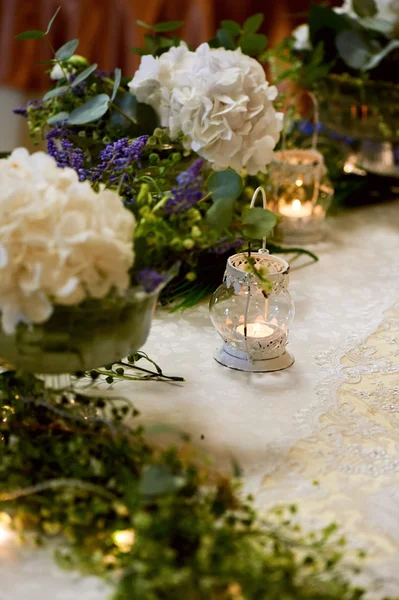 Bruiloft tafeldecoratie met witte hortensia's, een tafelkleed kant en Groenen, kaarsen — Stockfoto