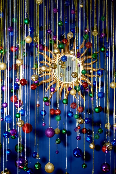 New Years garland of balls and rain against the blue wall. Bright festive colors.Celebrating the new year. — Stock Photo, Image