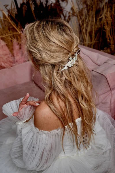 The brides hair, hairdressing. Blonde with curly hair.
