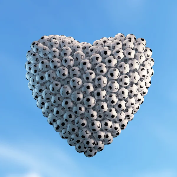 Forme de coeur composé de nombreux ballons de football avec éclairage dramatique. Image haute résolution — Photo