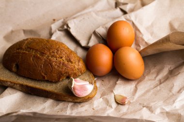 sarımsak, patates, ekmek ve tereyağı Kraft kağıt üzerinde