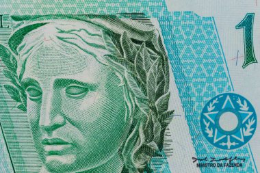 Brezilya 1 'e yakın çekim. Gerçek banknot, defne çelengi, yeşil ve mavi renkte bir kadın profili ve karmaşık çizgiler..