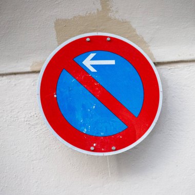 Kırmızı kenarlı, mavi kenarlı, yuvarlak bir trafik levhası ve 